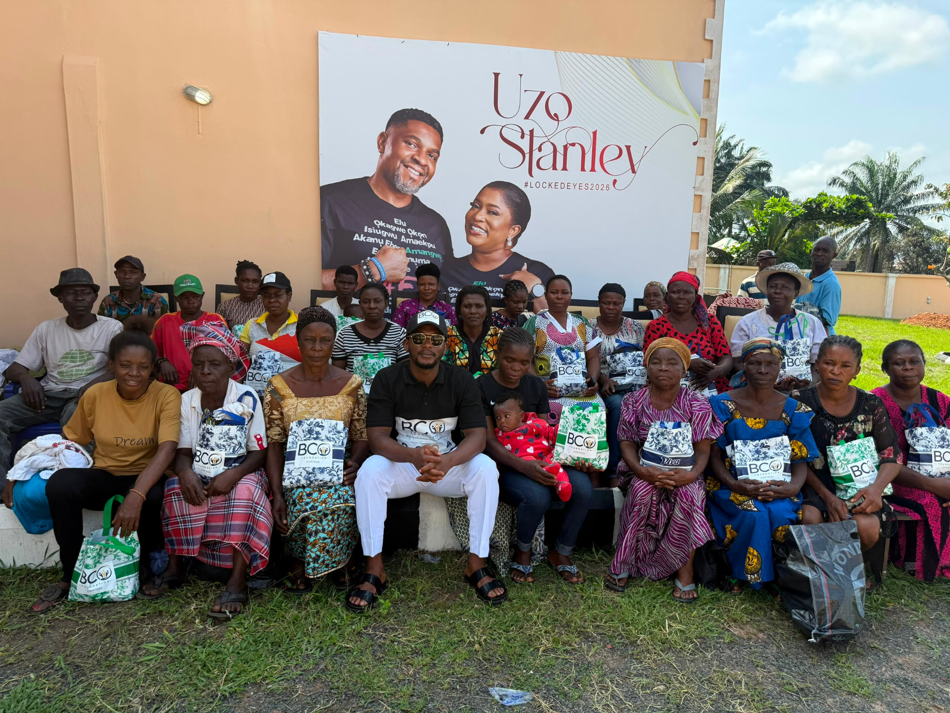 Community members holding BCO Foundation relief bags